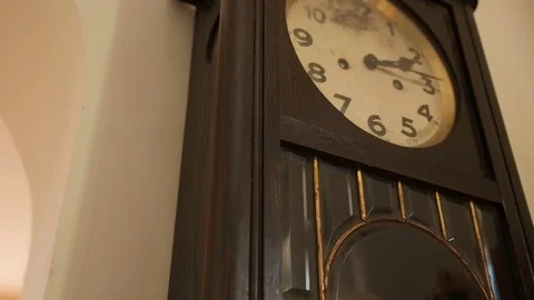 Antique wall clock with a pendulum closeup, tilt Stock Footage