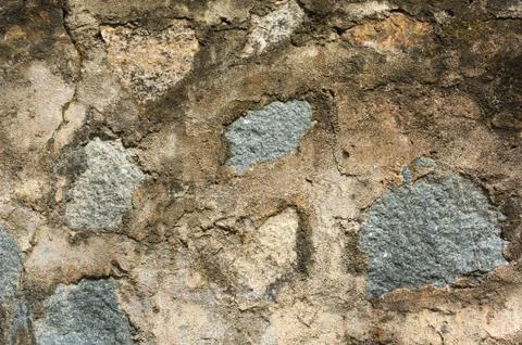 Antique wall made of multi colored rocks Stock Photos