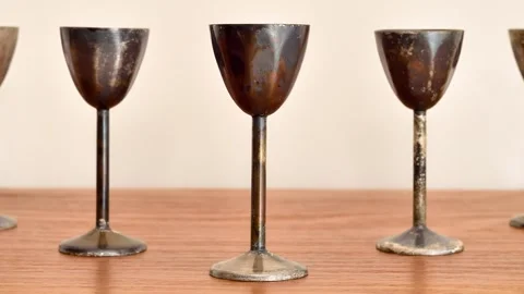 Antique weathered copper goblets on the table Video stock 281829550