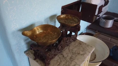 Antique weighing scale measuring granular food in historic kitchen Video stock 342131134