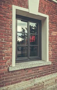 An antique window on a brick wall Stock Photos