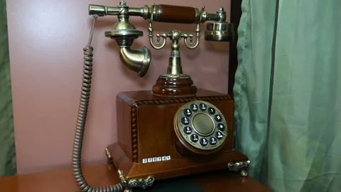 Antique wired disk telephone on the table in the interior of the room Stock Footage 121595770
