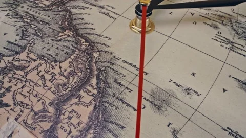 Antique world map clock running - slide and spin macro close up shot, 4k Stock Footage 130589961
