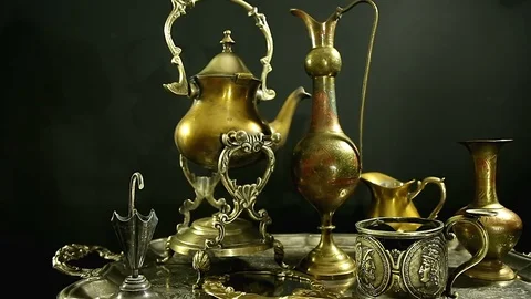 Antiques on an old silver tray on a dark background. Many different antiques. Stock Footage 98718315