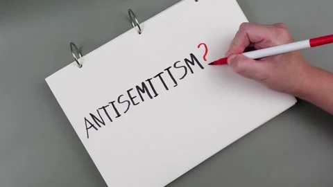 Antisemitism minimalistic concept. Hand is writing Word Antisemitism Stock Footage 260232156