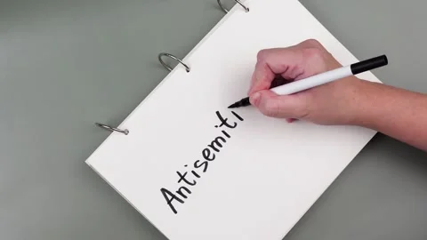 Antisemitism minimalistic concept. Hand is writing Word Antisemitism Stock Footage 260232364