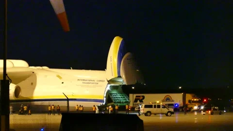 Antonov-225 deploying platform with people in white suit Stock Footage 139657689