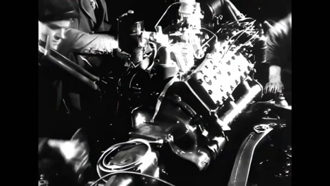 ANTWERP - 1948 - Workers lower an engine onto a chassis, test a car body in a 動画素材 316681034