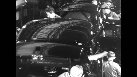 ANTWERP - 1948 - Workers use sewing machines at tables, inspect car bodies on an Stock Footage 316682551