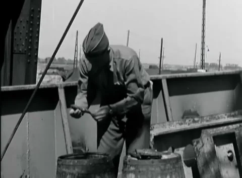ANTWERP, BELGIUM - 1945: Open barrels - Worker leans over cargo containers Stock Footage 344904344