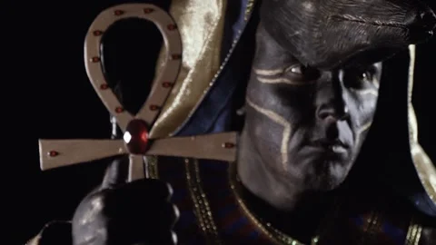 Anubis with the head of wild dog is looking at the ankh in his hand, close up Stock Footage 138003584