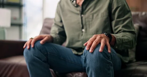 Anxiety, hands and man on sofa with stress, overthinking or mistake with wrong Stock-Footage 330570141