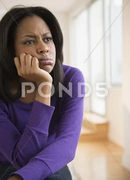 Anxious African American woman frowning Stock Photos