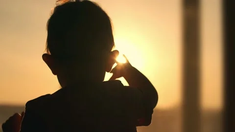 Anxious child knocks his hand on the window while standing inside the house Video stock 150316715