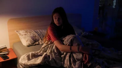 Anxious child sitting awake in bed at night suffering from sleep disorder Stock-Footage 336670364