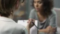 Anxious female patient talking with psychologist about her family problems HD Footage