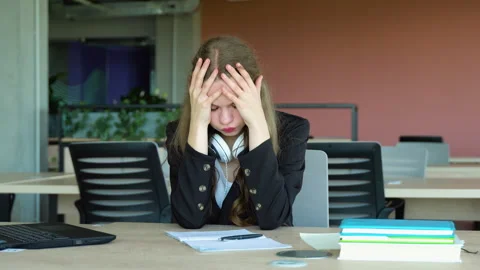 Anxious girl feeling tired while studying at school. College student suffering Stock Footage 243315586