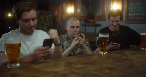 Anxious man checking bets on cellphone, watching sports in bar, bookmaker app Stock Footage 158661358