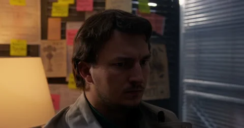 Anxious man at dusk in office by window, fear foreboding Dangerous Investigation Stockbeeldmateriaal 251765471