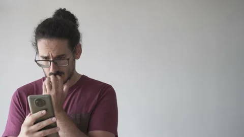 Anxious man looking at smartphone and biting his nails with copy space Stock Footage 161551951