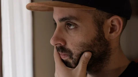 Anxious man thinks in front of the window. Close up face of caucasian man Stock Footage 125526403