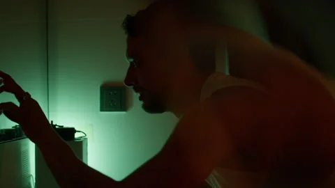 Anxious Man touches mirror surface in Dim Light, Reflecting Tension and Unease Video stock 319623418