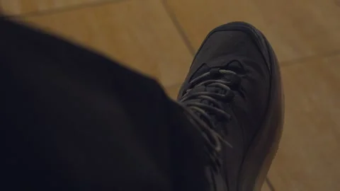 Anxious person nervously tapping foot on tiled floor Stock Footage 329592671