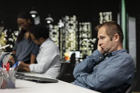 Anxious programmer in tech company office nervous after noticing error 스톡 사진