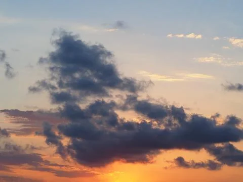 Anxious sunset. Many clouds of different colors in the rays of the sun Fotos de archivo