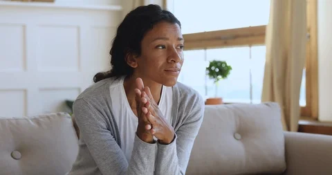 Anxious thoughtful african woman on sofa looking away feel depressed Stock Footage 118250737