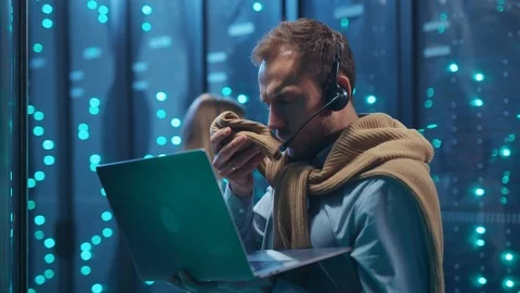 Anxious young IT administrator typing on laptop keyboard turning off data center Stock Footage 119977120