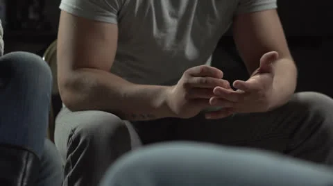 Anxious young man at therapy session picking at his skin Stock Footage