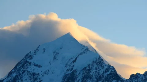 Aoraki, Mount Cook face with cloud forming over mountain peak on sunrise Stock Footage 69036424