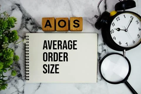 AOS Average Order Size text with alarm clock and magnifying glass on marble.. Stock Photos
