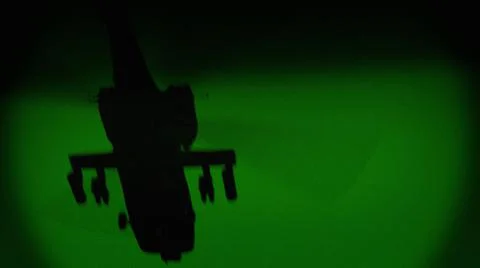 Apache AH-64 helicopter flies at night, night vision infrared Stock Photos