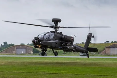 Apache AH1 gunship lands on the grass Stock Photos