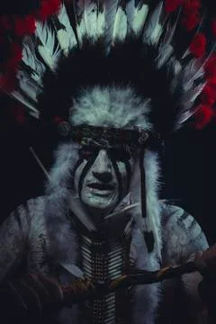 Apache, American Indian chief with feather headdress and traditional war ax Stock Photos