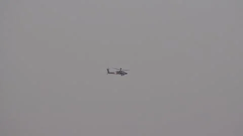 Apache attack helicopter flying far distance en route to combat operation role Video stock 291268361