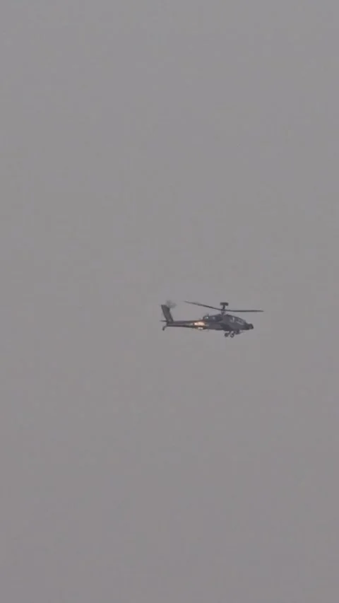 Apache attack helicopter flying far distance en route to combat operation role Vídeos de archivo 296766764