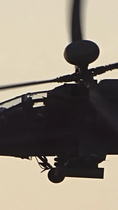 Apache attack helicopter flypast backlit by sun during route for combat Vídeos de archivo 296766772