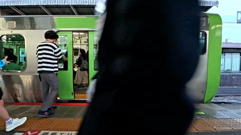 Apanese conductor or train driver on JR Yamanote Line signal to open the door Stock Footage 189496651