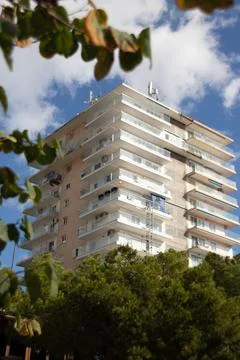 Apartment block towering over tree Palma Nova Stock Photos