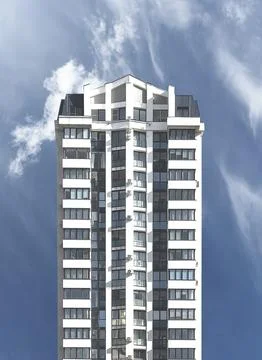 Apartment building with angular structure. Tall narrow tower with white facad Stock Photos