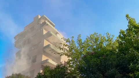 Apartment building collapsing and tilting during demolition Stock Footage 346543345