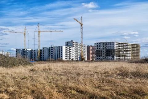 An apartment building complex is being built on an abandoned agricultural fie Stock Photos