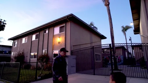 Apartment Complex Evening with People walking in front Video stock 92402704