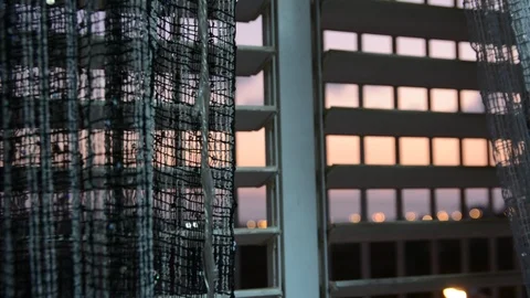 Apartment curtained window with city view in the evening. Looking out the window Vídeo Stock 115664943