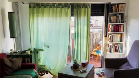 Apartment dining room with large open window and curtains armchairs and a dog Stock Footage 246059330