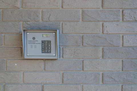 Apartment intercom panel on brick facade exterior Stock Photos