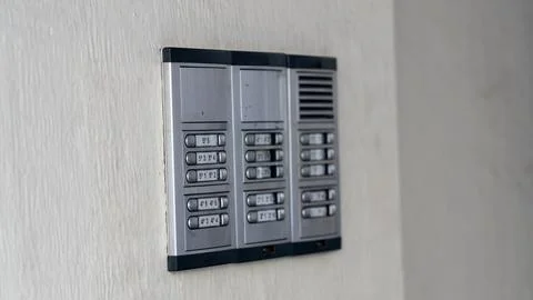 Apartment Intercom System With Numbered Call Buttons on White Wall Photos